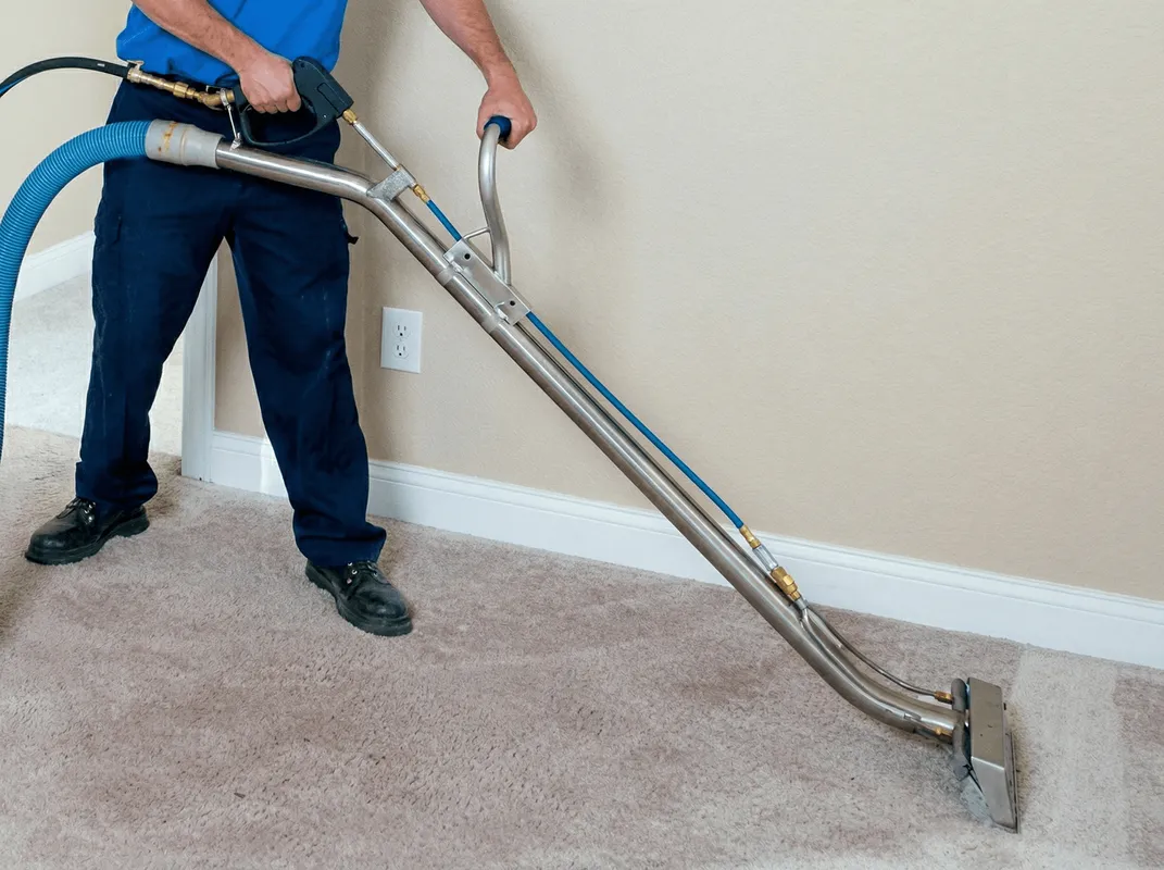 Professional operating a liquid removal machine on a carpeted floor in Fargo, ND